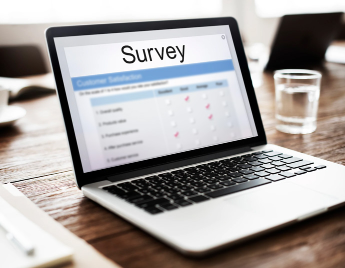 picture of a computer with the word "Survey" on screen